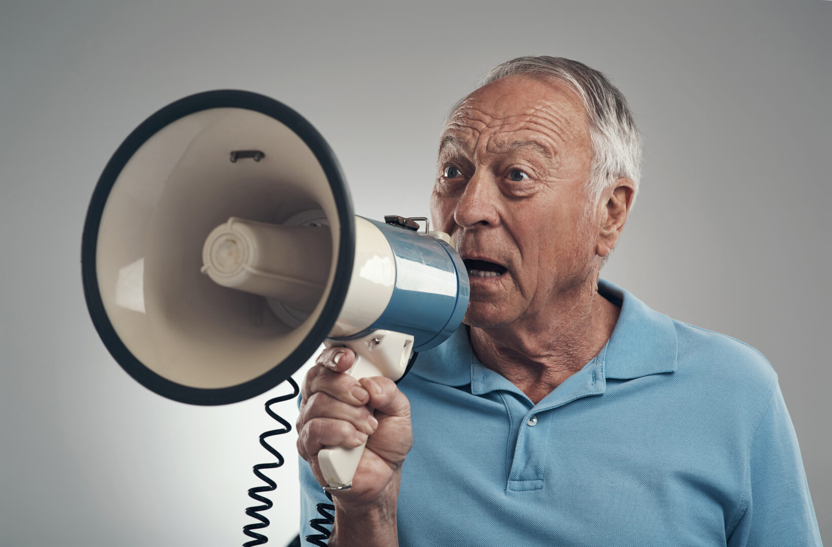 shot-of-an-old-man-holding-and-speaking-through-a-2023-11-27-05-23-56-utc